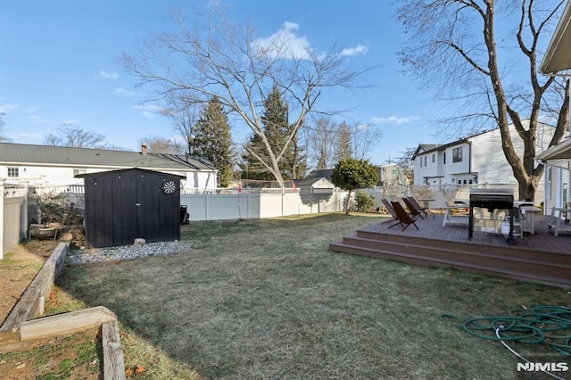 view of yard featuring a shed and a wooden deck