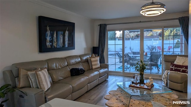 living room featuring a wealth of natural light, crown molding, and hardwood / wood-style floors