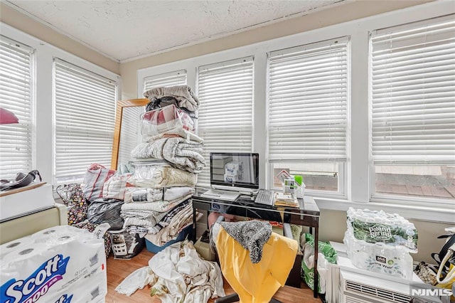 miscellaneous room with wood-type flooring, plenty of natural light, and ornamental molding