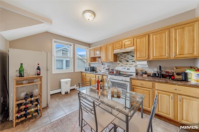 kitchen featuring baseboard heating, light brown cabinetry, tasteful backsplash, light tile patterned flooring, and gas range gas stove