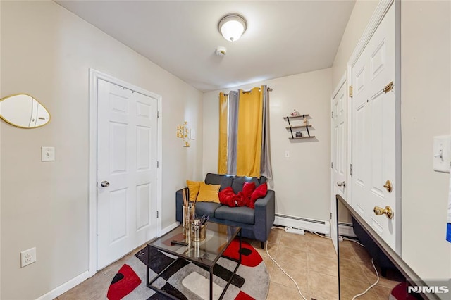 sitting room featuring baseboard heating and light tile patterned floors