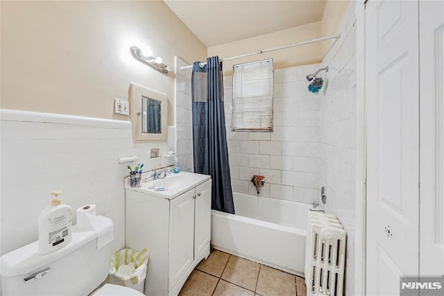 full bathroom featuring shower / bath combo, vanity, radiator, tile patterned floors, and toilet