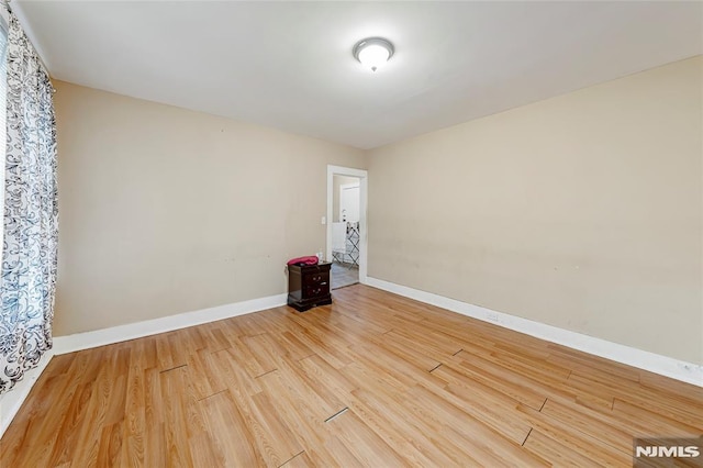 spare room with hardwood / wood-style flooring