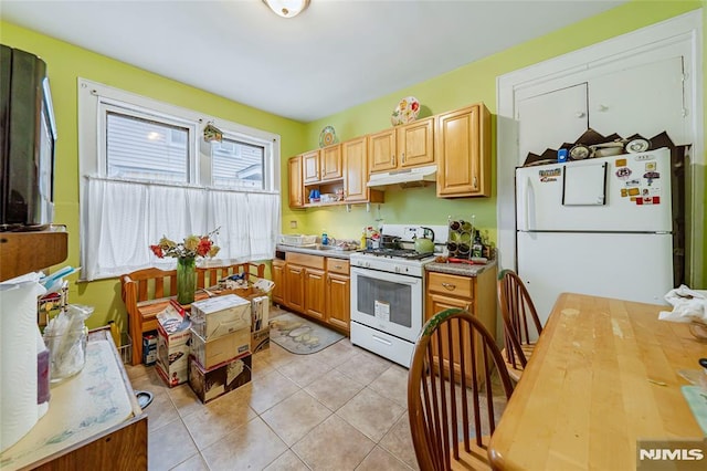 kitchen with sink, white appliances, and light tile patterned flooring