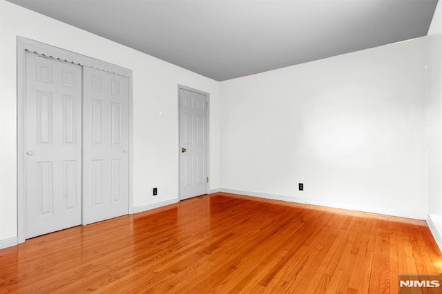 unfurnished bedroom with wood-type flooring