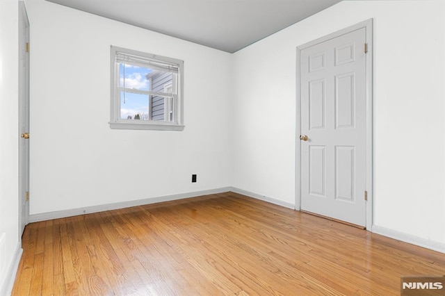 unfurnished room with light hardwood / wood-style floors