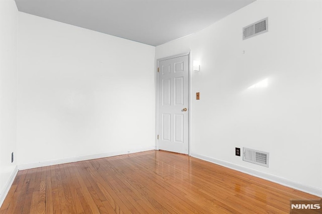 spare room featuring hardwood / wood-style floors