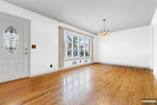 entrance foyer featuring a chandelier and light hardwood / wood-style flooring