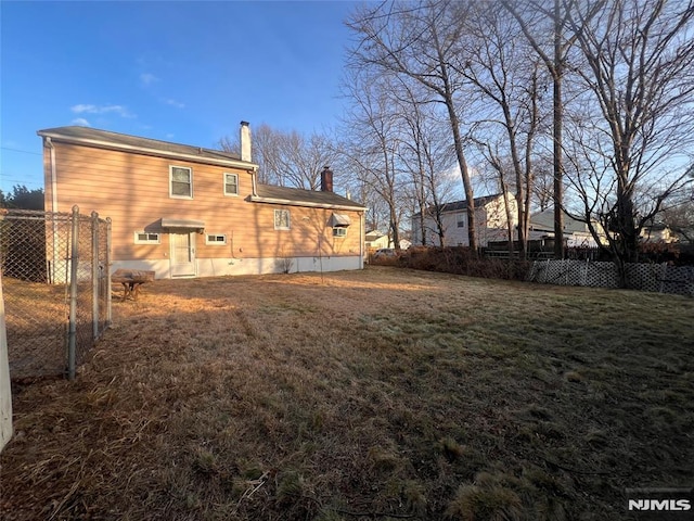 rear view of house with a yard