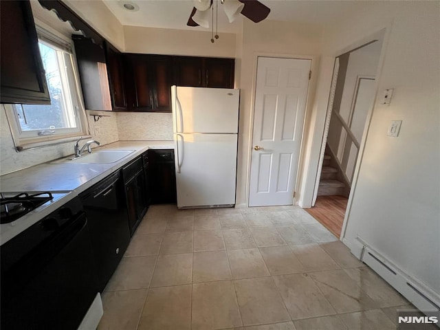 kitchen featuring dishwasher, sink, a baseboard radiator, white refrigerator, and stove