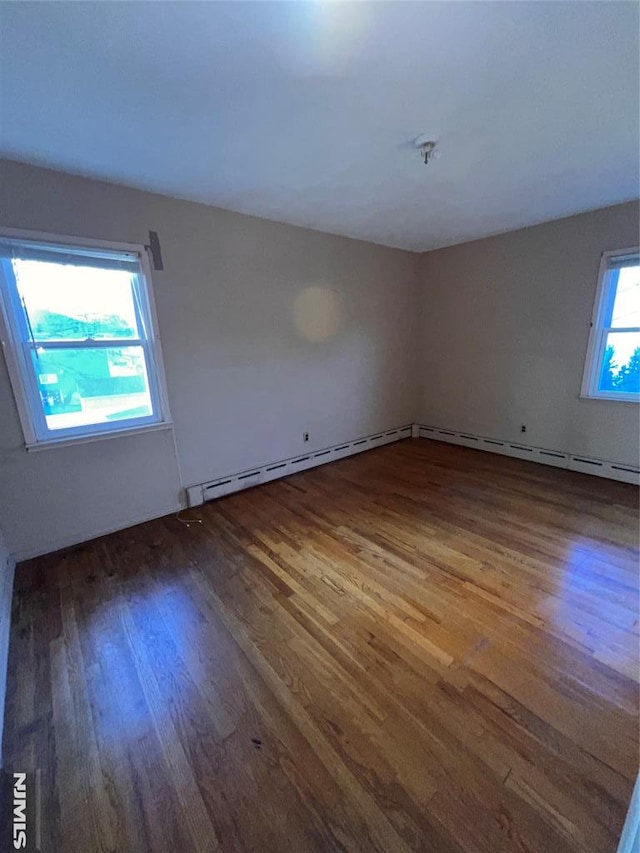 unfurnished room with hardwood / wood-style floors and a wealth of natural light