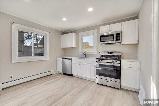 kitchen featuring light hardwood / wood-style floors, white cabinetry, appliances with stainless steel finishes, a baseboard radiator, and sink