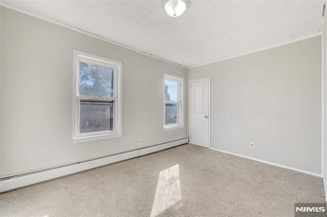 carpeted spare room featuring a baseboard radiator and ornamental molding