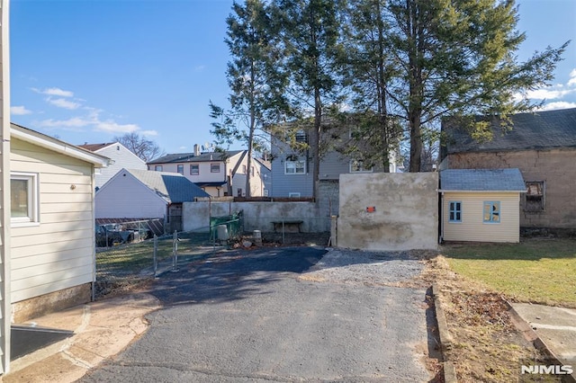 view of gate featuring a storage unit