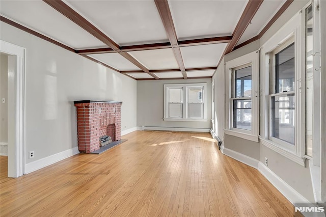 unfurnished living room with coffered ceiling, light hardwood / wood-style floors, a baseboard heating unit, a fireplace, and beamed ceiling