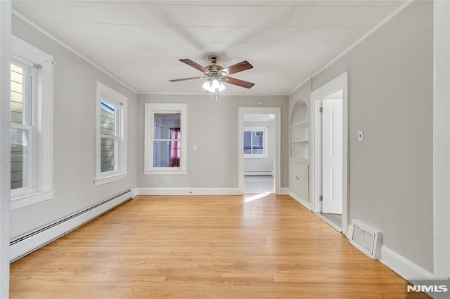 empty room with baseboard heating, ceiling fan, light hardwood / wood-style floors, and crown molding