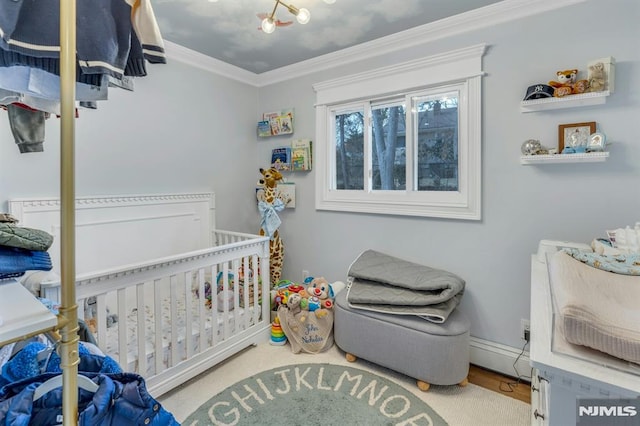 bedroom featuring ornamental molding and a nursery area