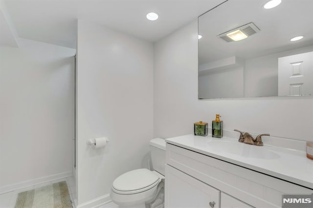 bathroom with toilet and vanity