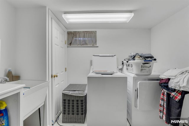 clothes washing area with washing machine and dryer