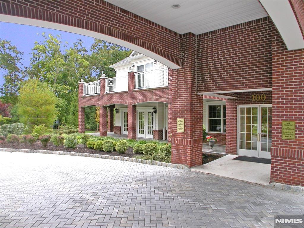 view of front of house with french doors and a balcony