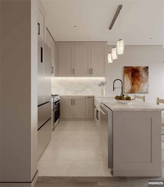 kitchen featuring kitchen peninsula, stainless steel appliances, backsplash, decorative light fixtures, and light stone counters