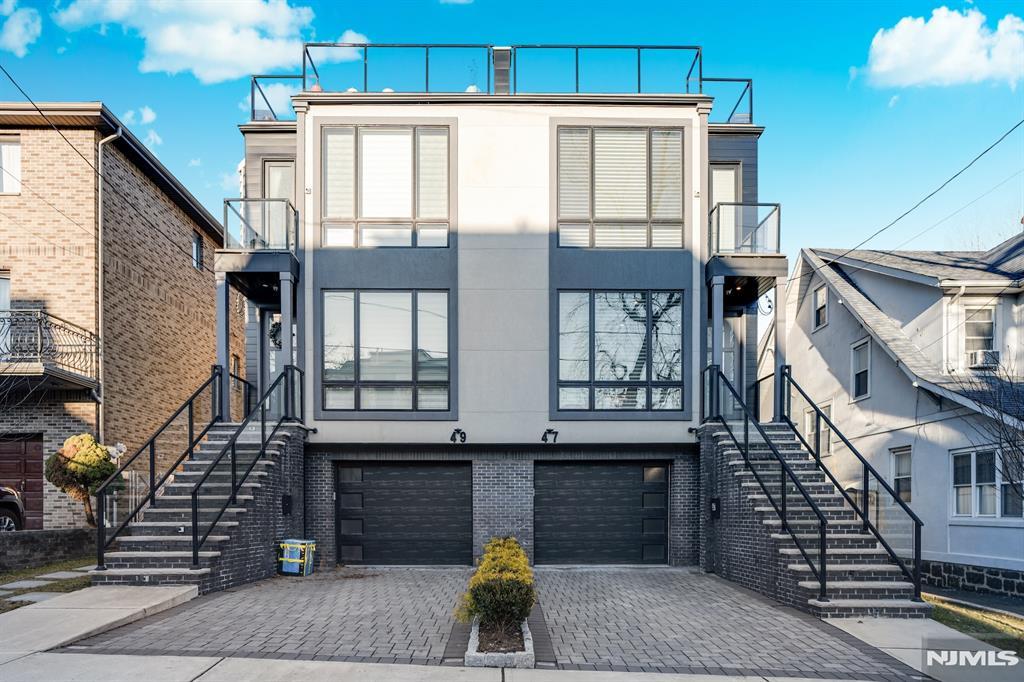 view of front of property featuring a balcony and a garage