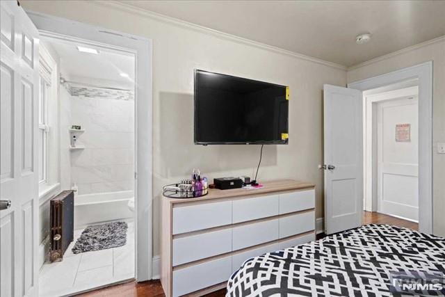 bedroom with hardwood / wood-style flooring and ornamental molding