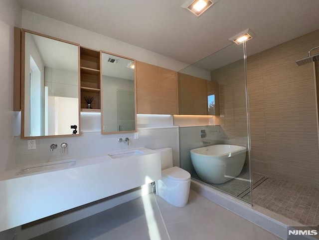 full bathroom featuring vanity, toilet, tile walls, and plus walk in shower