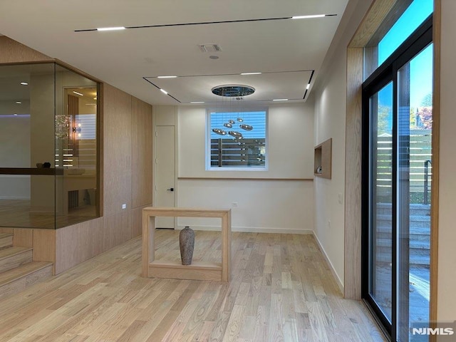 hallway with french doors and light hardwood / wood-style flooring