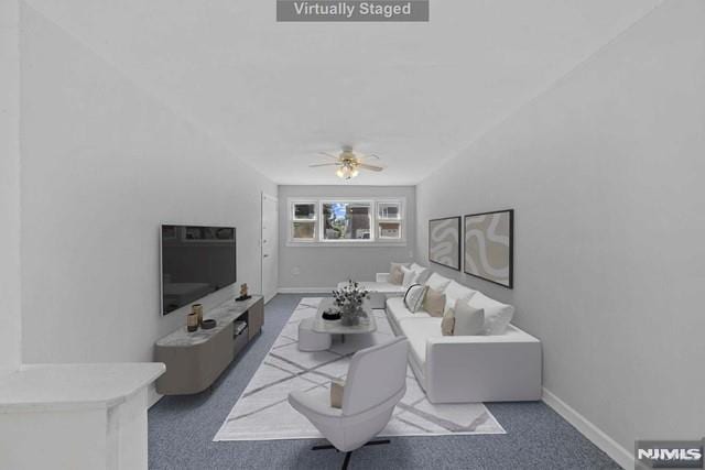 living room with ceiling fan and dark colored carpet