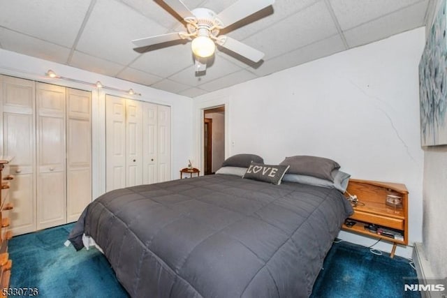 carpeted bedroom with multiple closets and ceiling fan