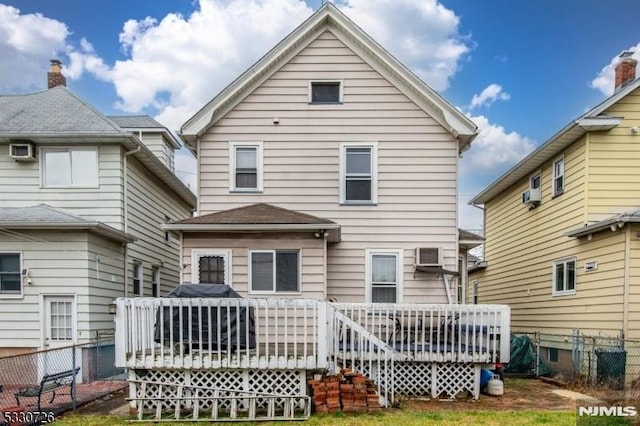 back of property featuring a wooden deck