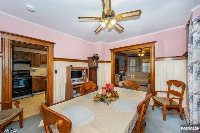 dining space featuring ceiling fan and ornamental molding