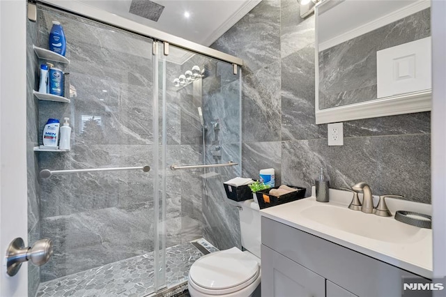 bathroom with vanity, toilet, ornamental molding, and walk in shower