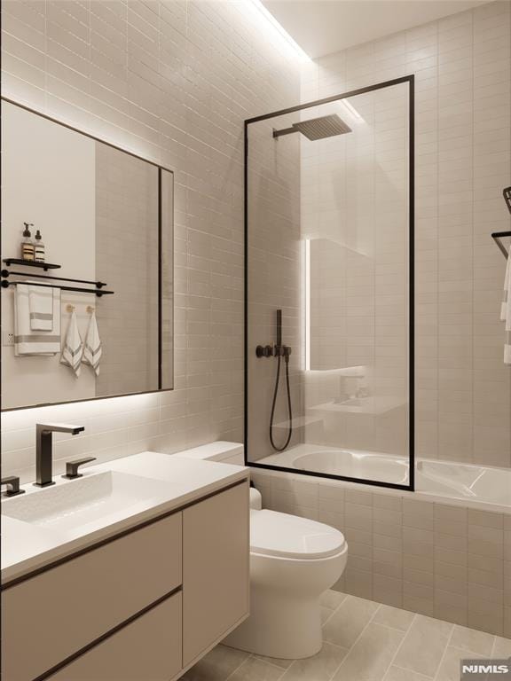 full bathroom featuring tile patterned floors, vanity, bath / shower combo with glass door, tile walls, and toilet