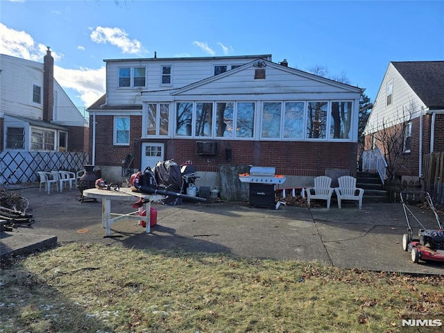 back of house featuring a patio area and a sunroom