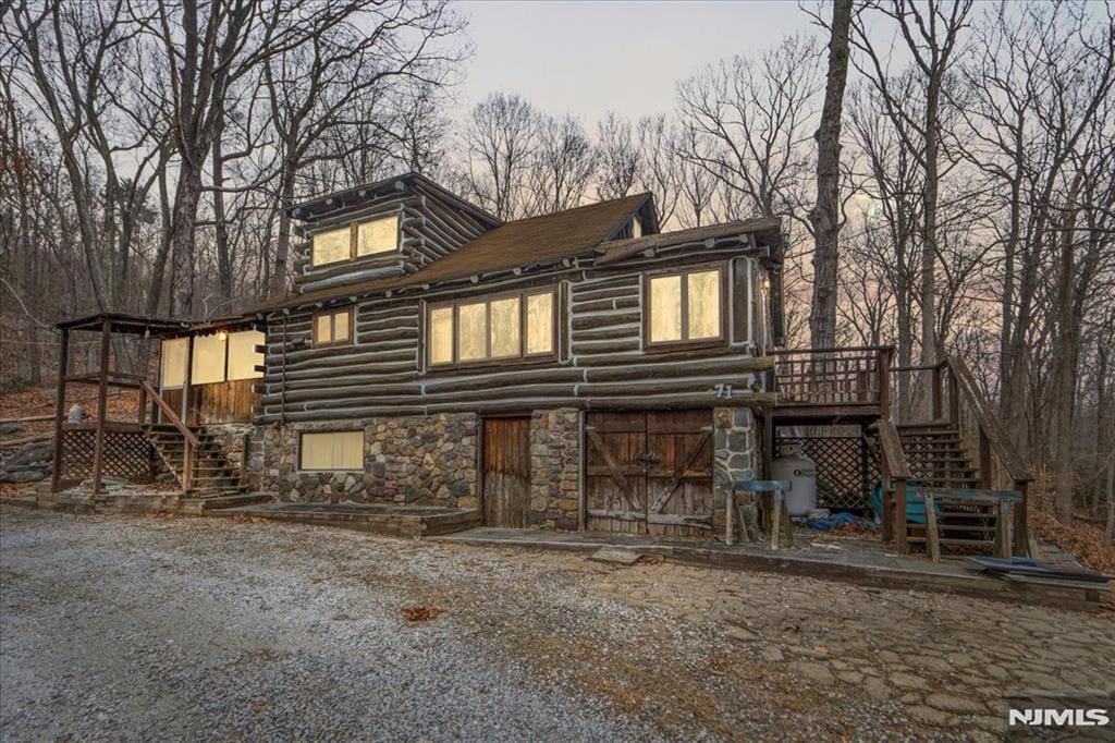 back of house featuring a wooden deck