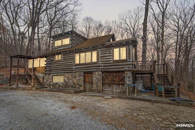 back of house featuring a wooden deck