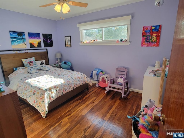 bedroom with a ceiling fan, baseboards, and wood finished floors