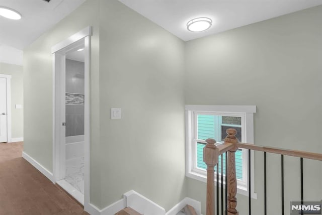 hallway with hardwood / wood-style floors