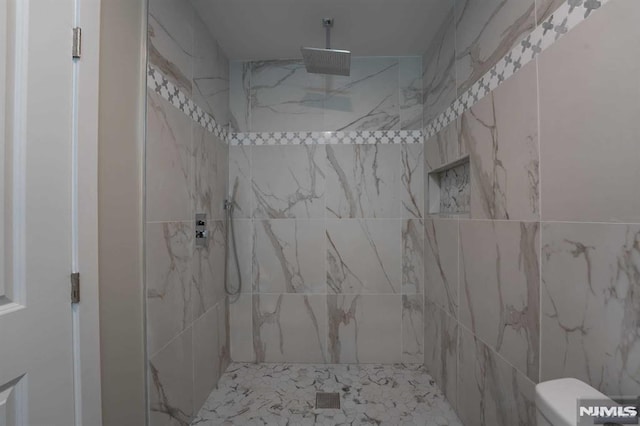 bathroom with a tile shower