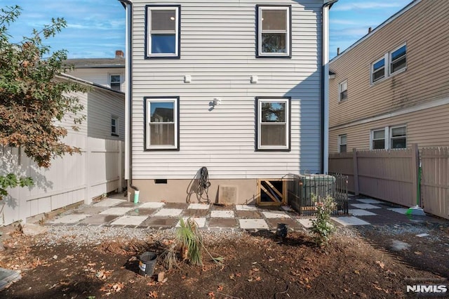 rear view of house featuring cooling unit