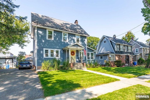 colonial home featuring a front yard