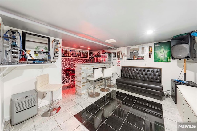 miscellaneous room with tile patterned floors and bar area