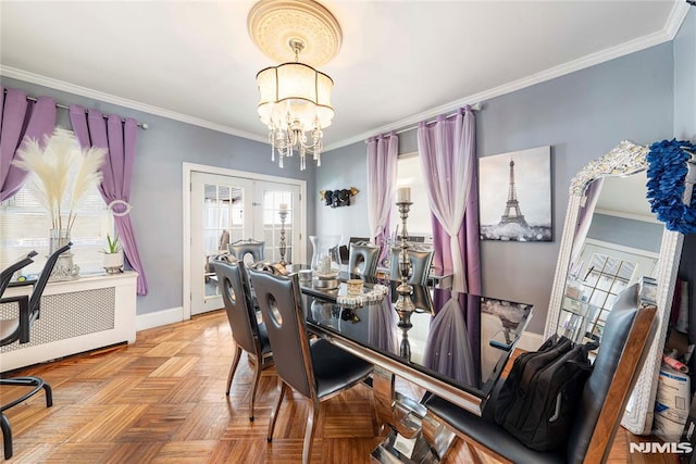 dining space featuring light parquet flooring, ornamental molding, french doors, and an inviting chandelier