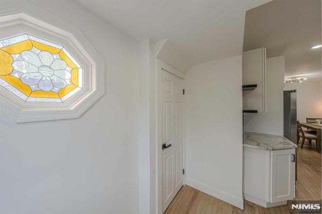 corridor featuring light hardwood / wood-style flooring