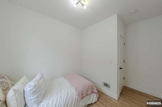 bedroom with light hardwood / wood-style floors