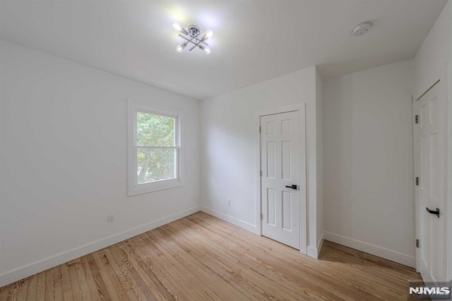 unfurnished room with light hardwood / wood-style floors