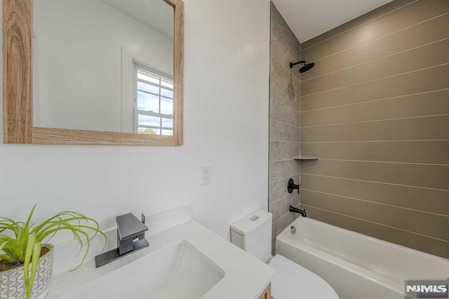 full bathroom with vanity, toilet, and tiled shower / bath