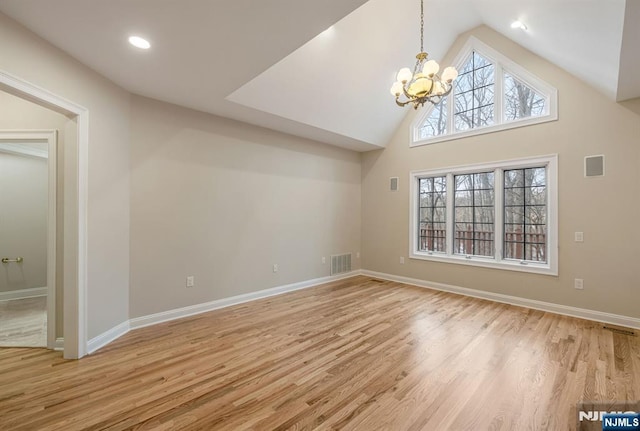 interior space with a notable chandelier, baseboards, visible vents, and light wood-style floors